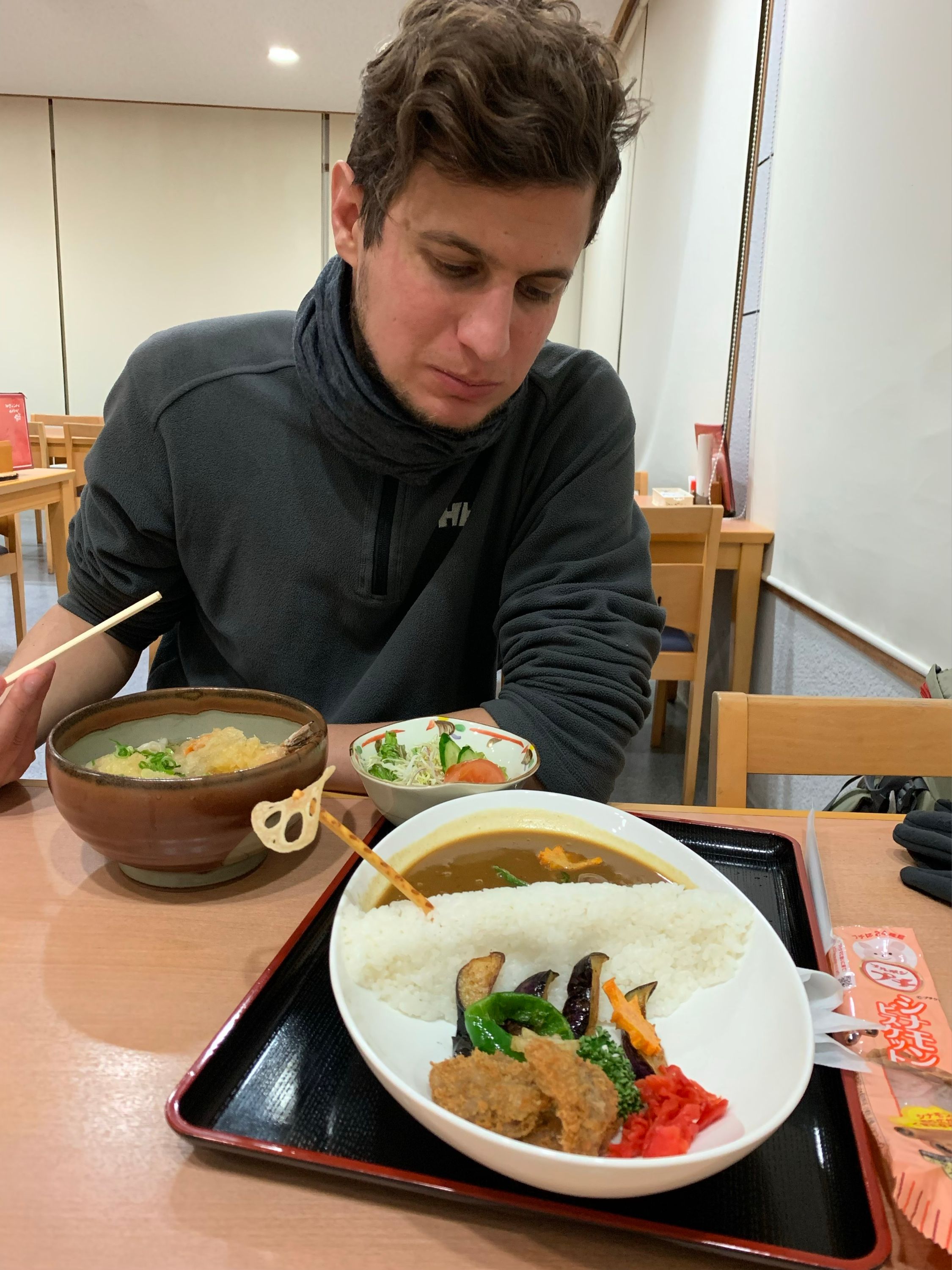 A man, Gyula Simonyi, looks at the actual dish with an expression between curiosity and disapproval.