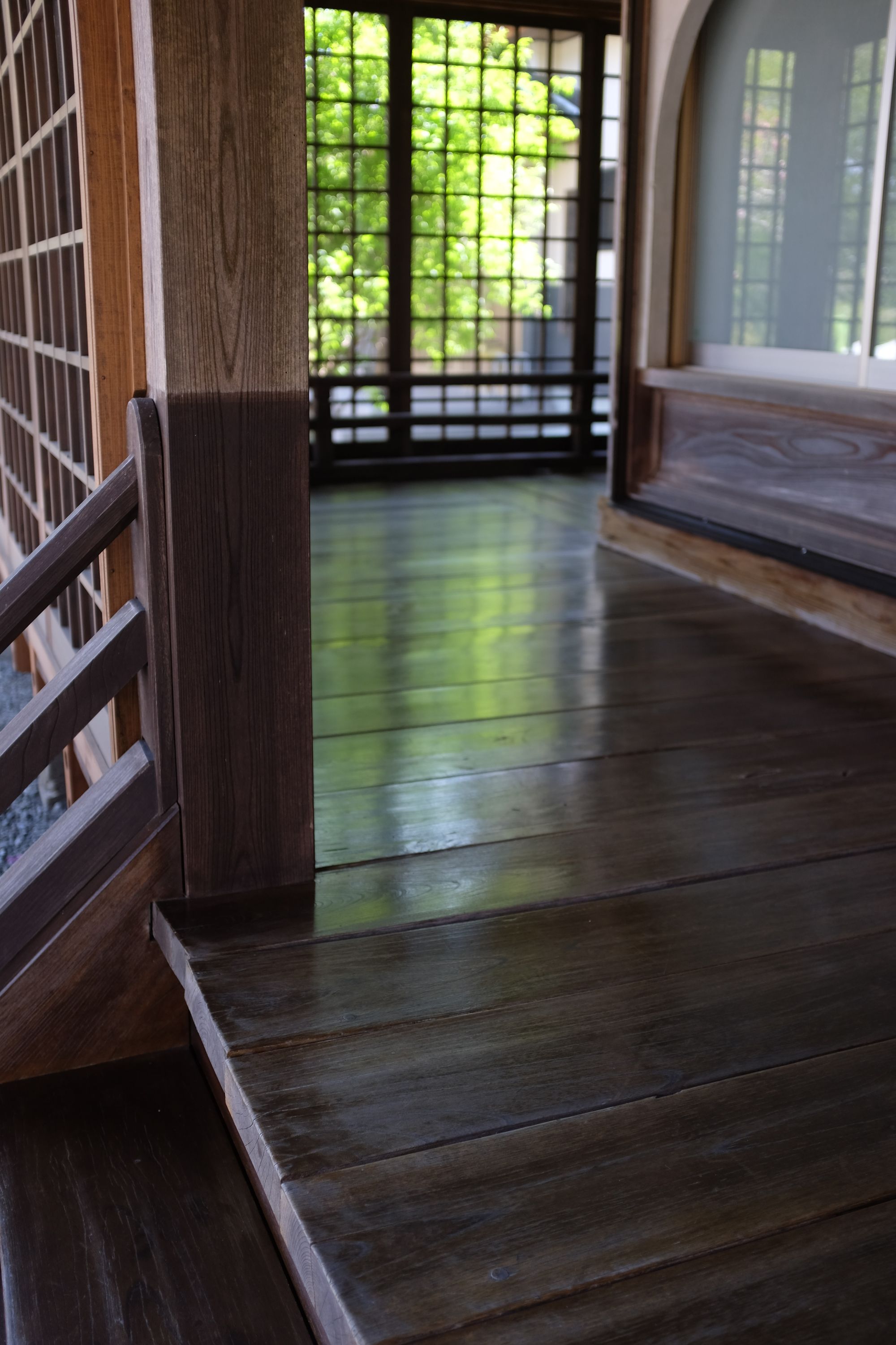 The polished wood floor of the porch of the temple.