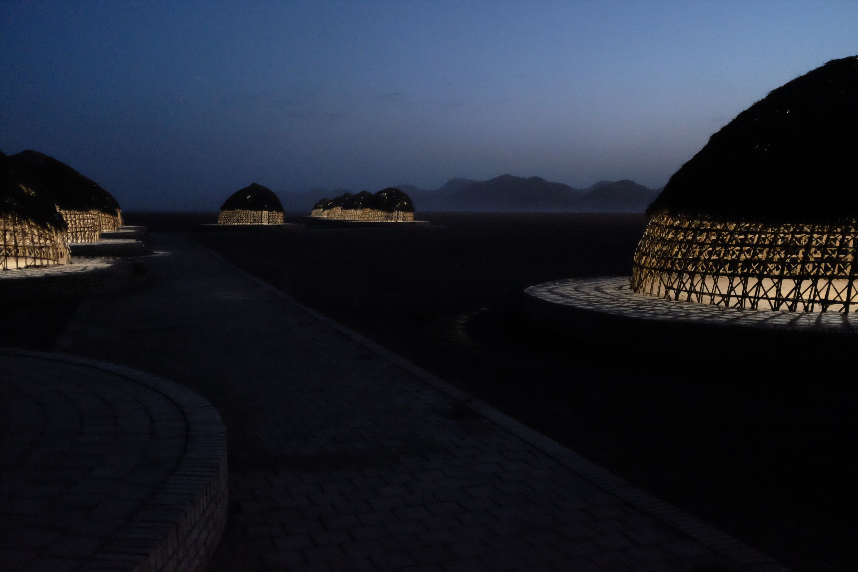 In the evening light, dome-shaped structured in the tent which are lit up from the inside