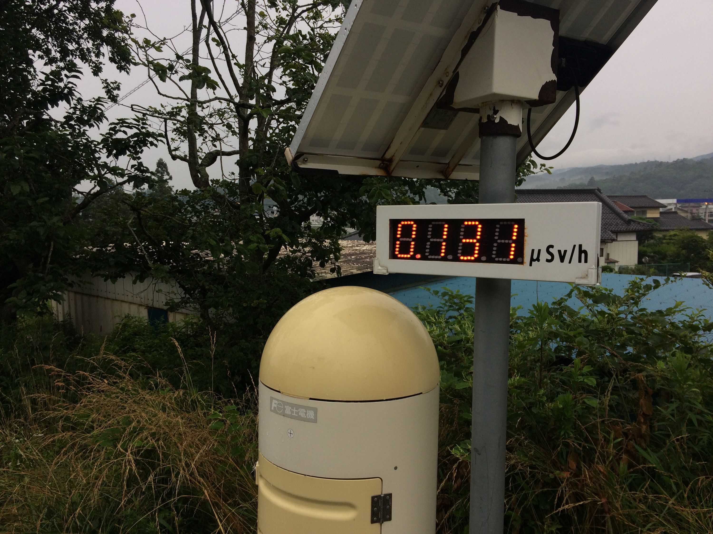 A yellow radiation monitor by the side of the road.