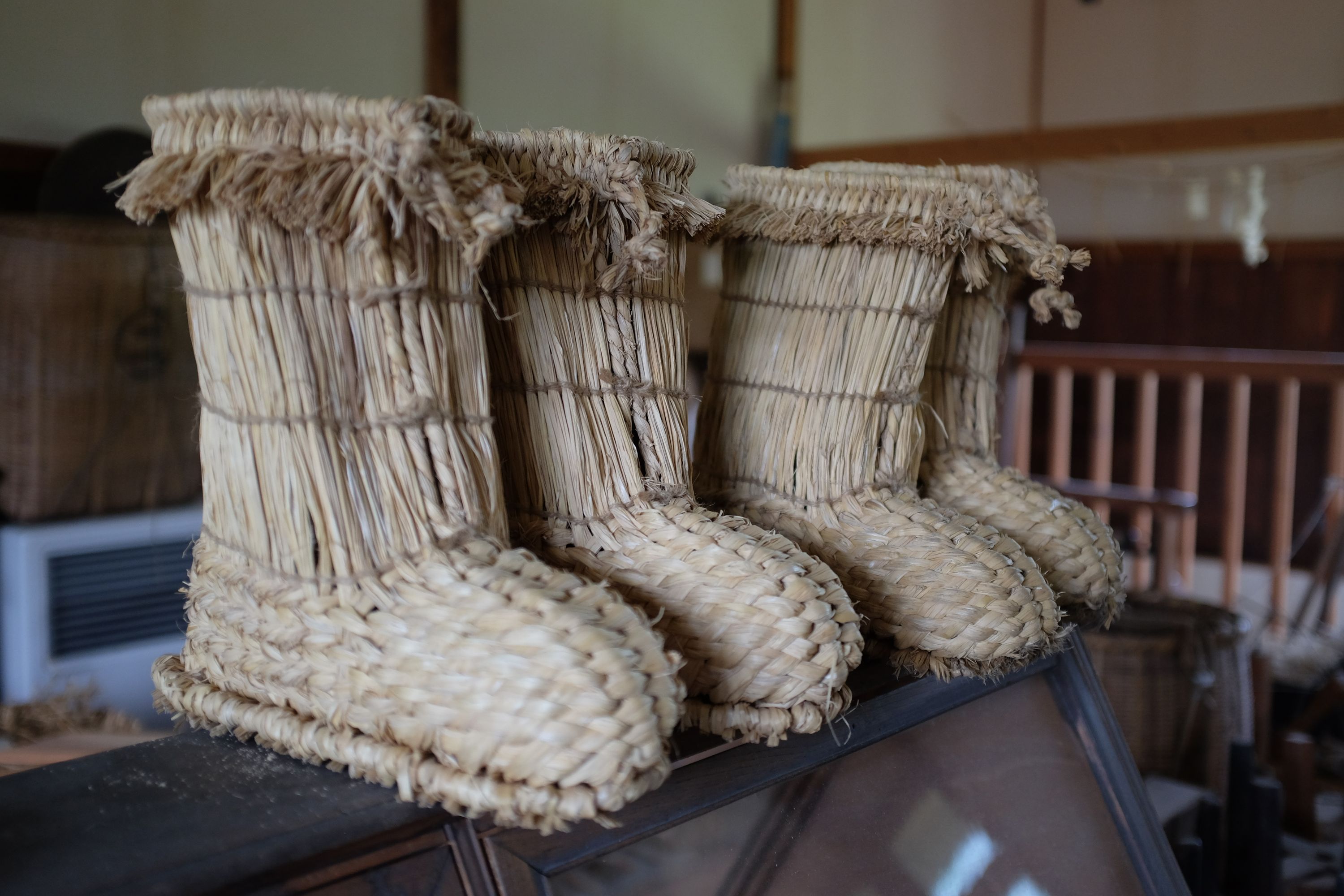 Two pairs of straw boots.