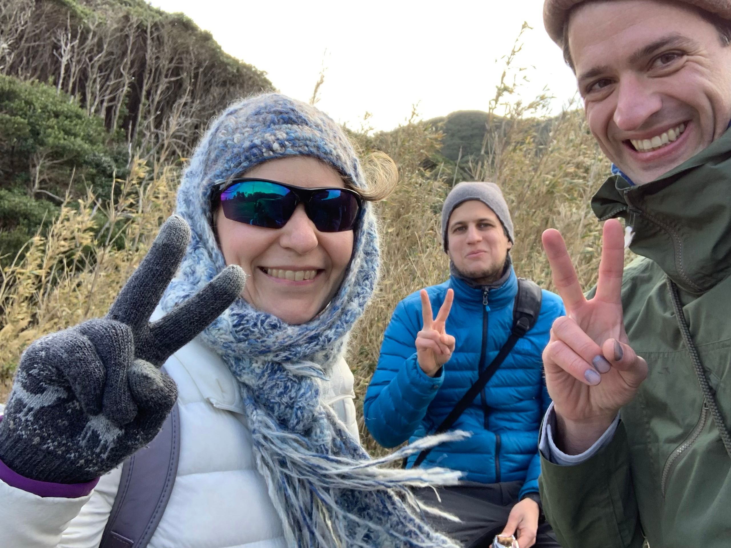 From left to right: a woman in sunglasses and a knit hat (Hanga Yoshihara-Horváth), a man in a blue down jacket (Gyula Simonyi), and another man in a green canvas jacket (Peter Orosz, the author) smile into the camera.