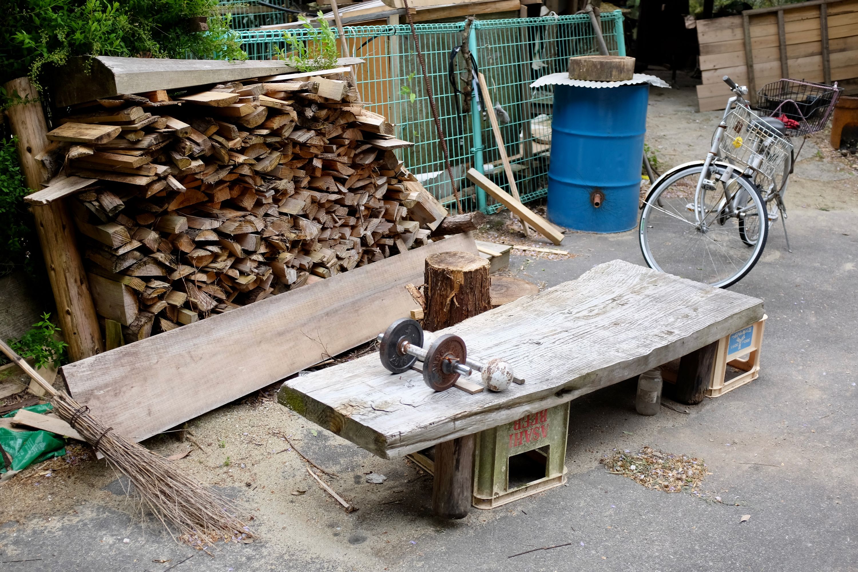 A bench for doing bench presses made of a slab of wood and two beer crates.