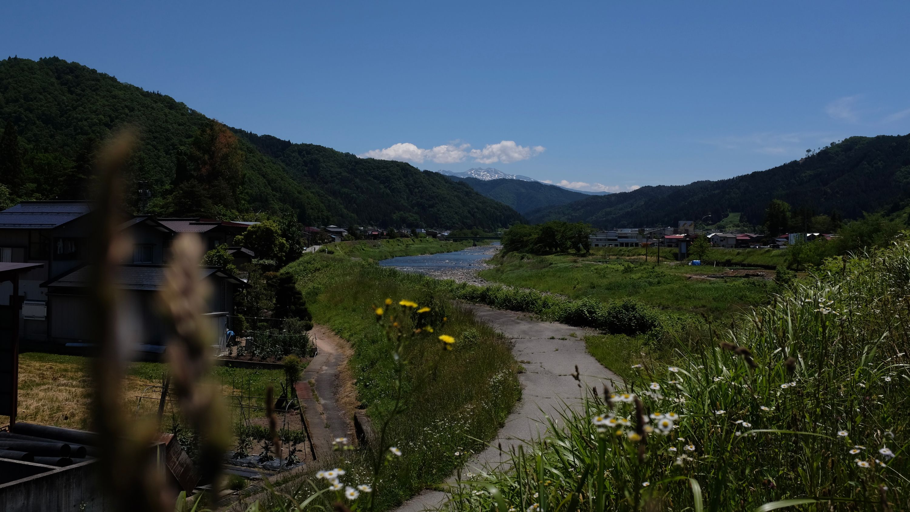 Looking southeast on the road between Furukawa and Takayama in Hida, with Mount Norikura on the horizon.