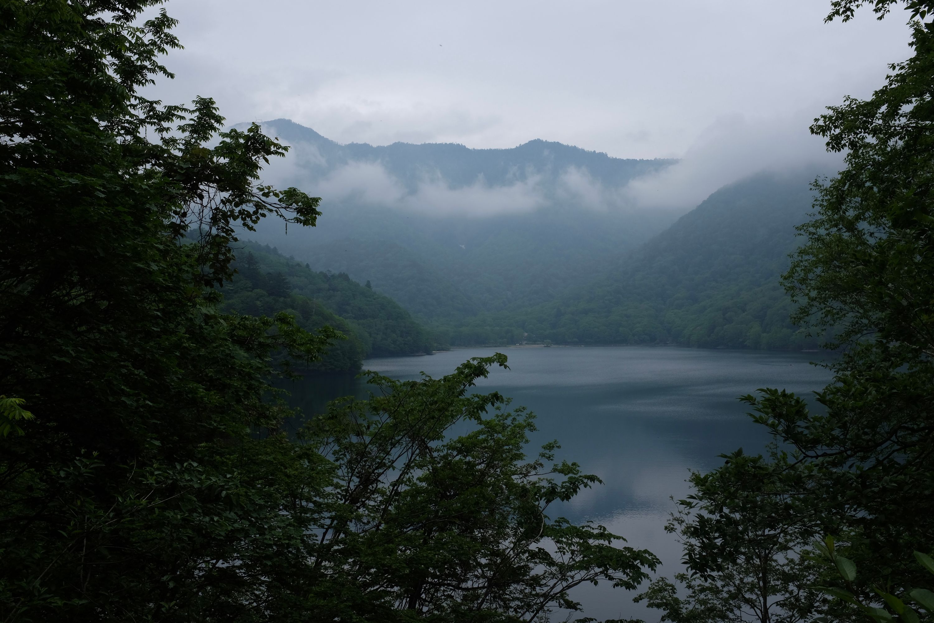 A lake in the mountains under a cloudy sky.