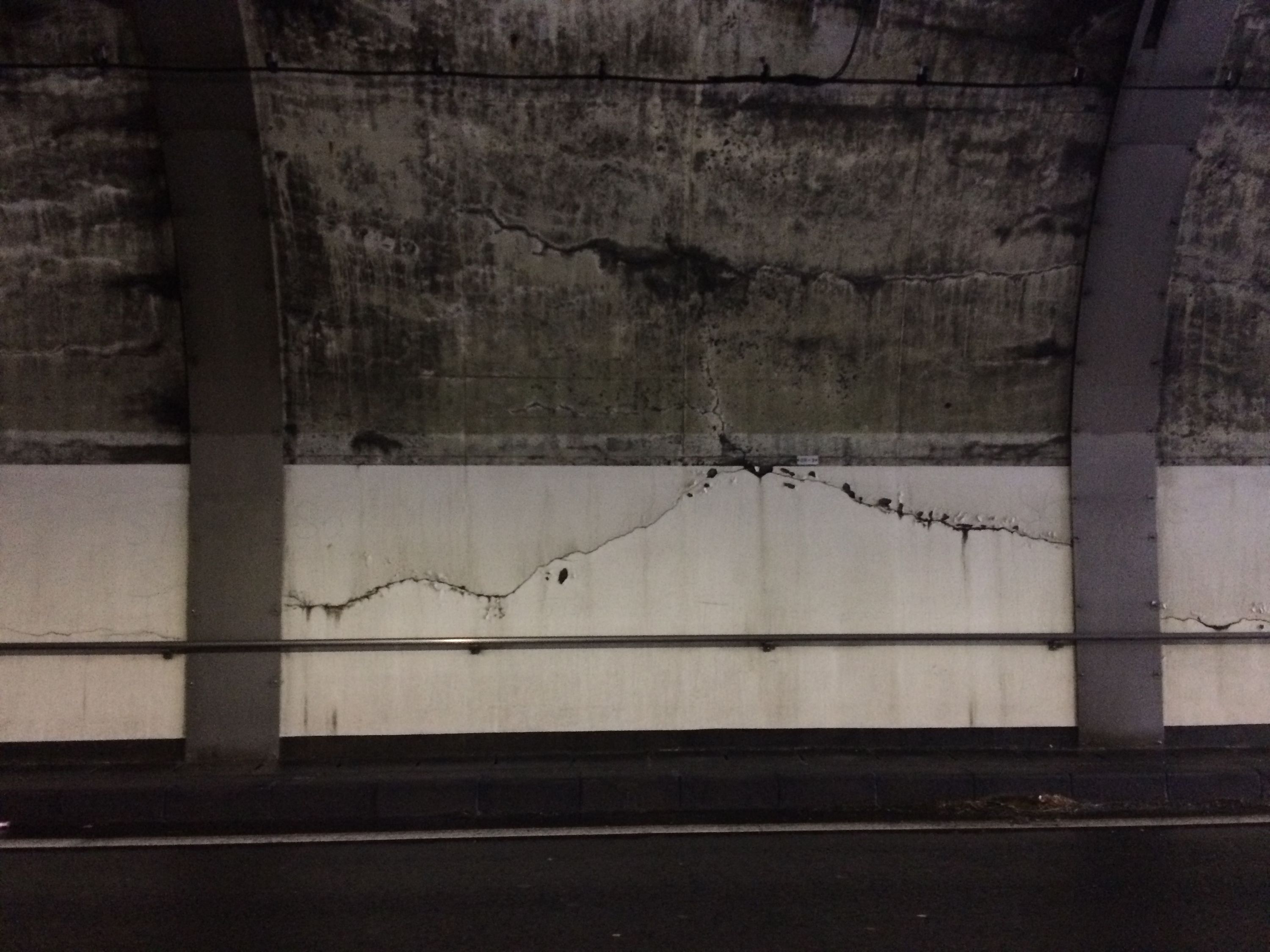 Cracks on the wall of a tunnel.