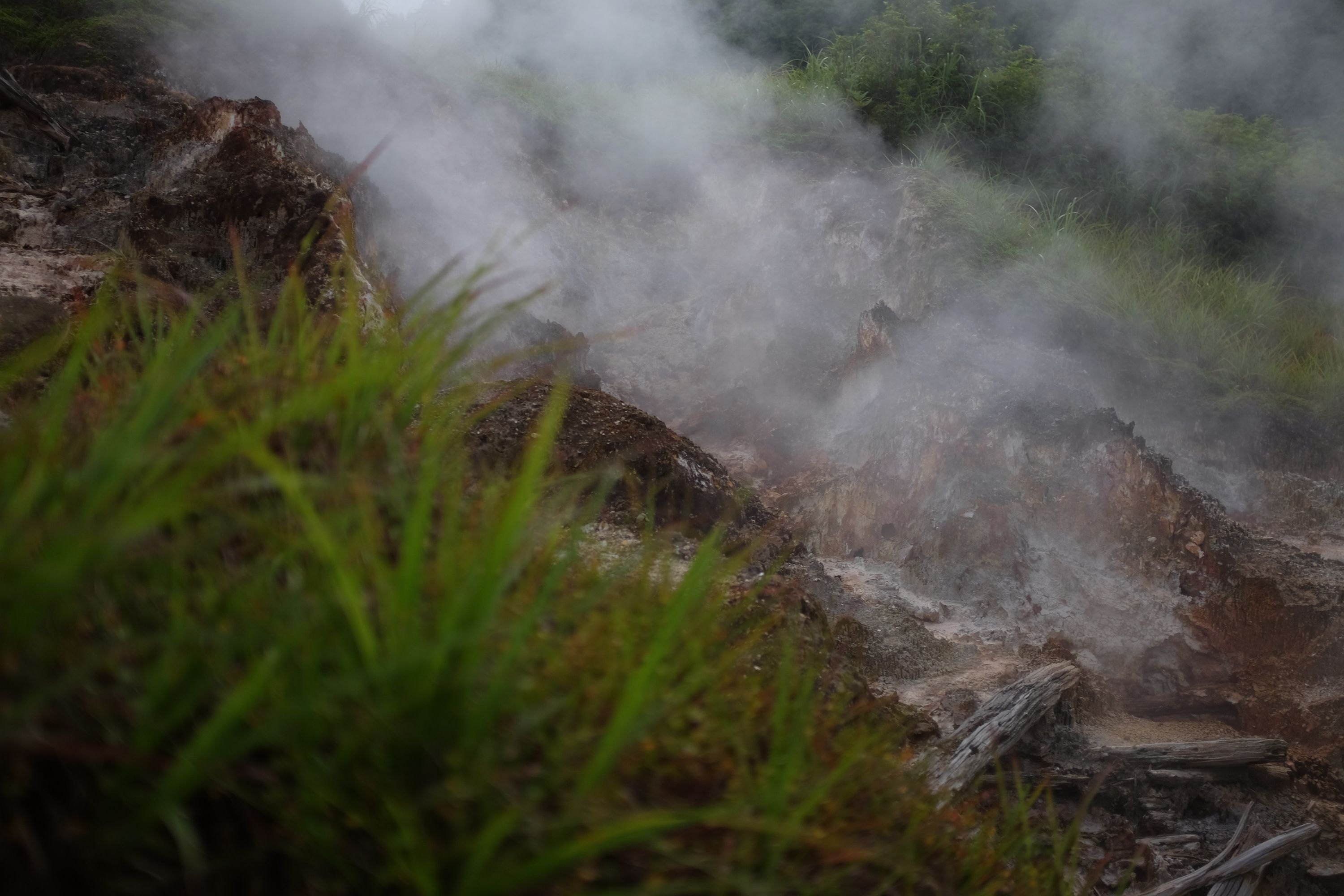 Another hot spring flows from a rocky hillside.