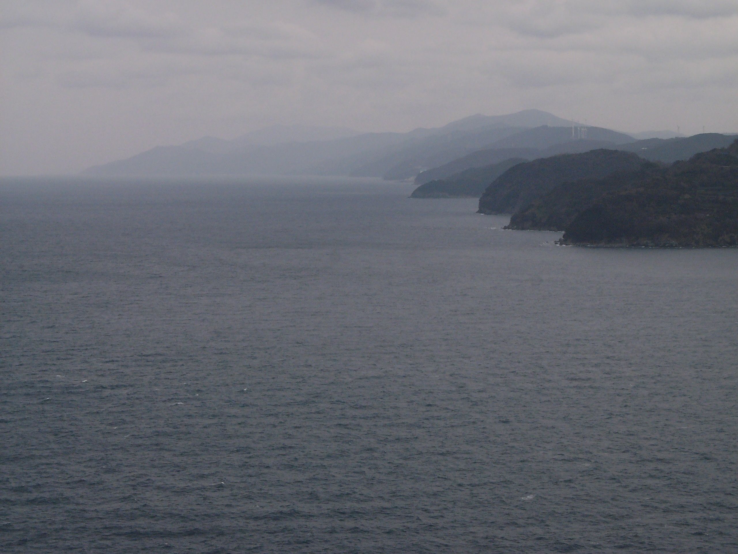 Panorama of a series of small peninsulas on a grey sea.