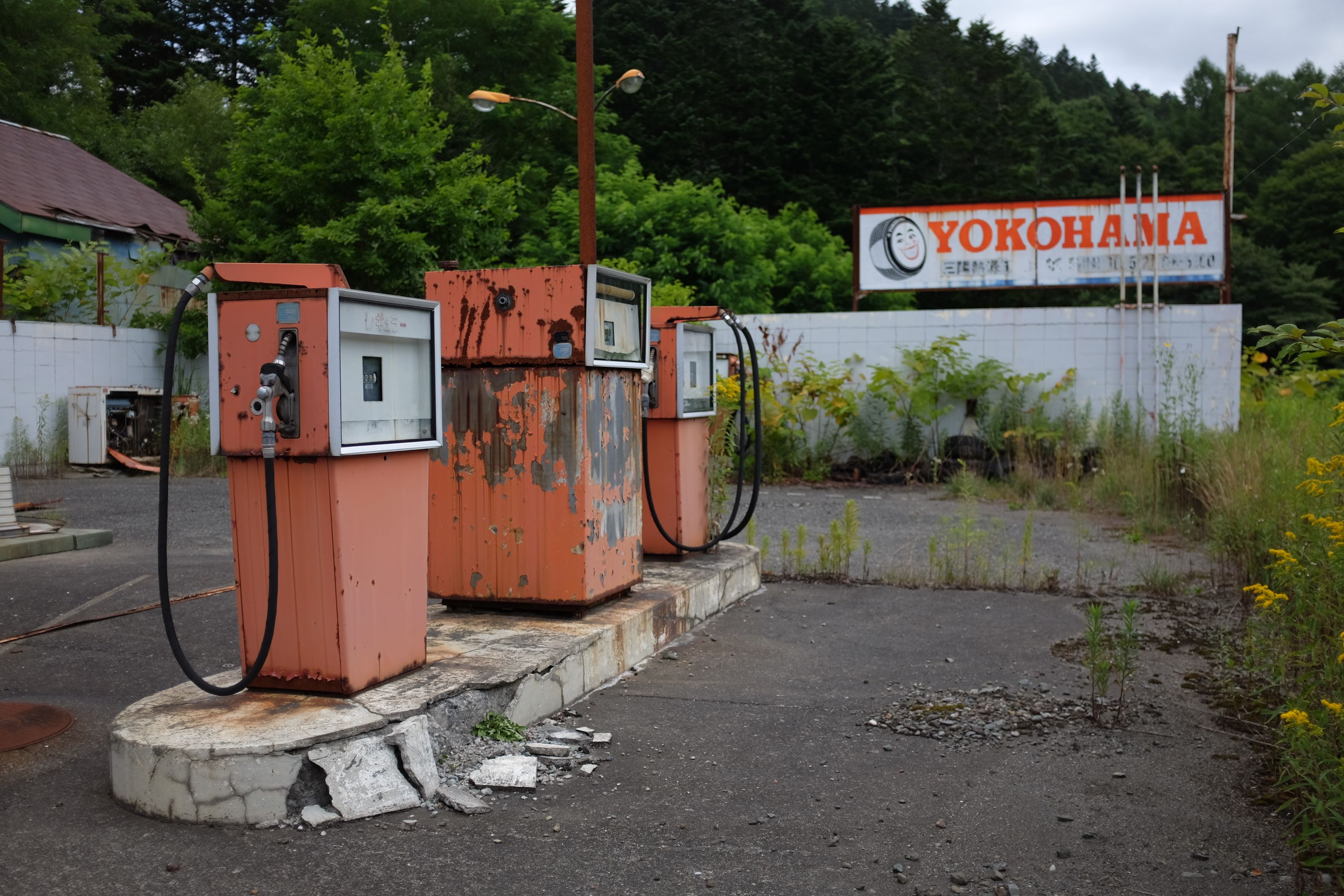 Rusting pumps at an abandoned filling station.