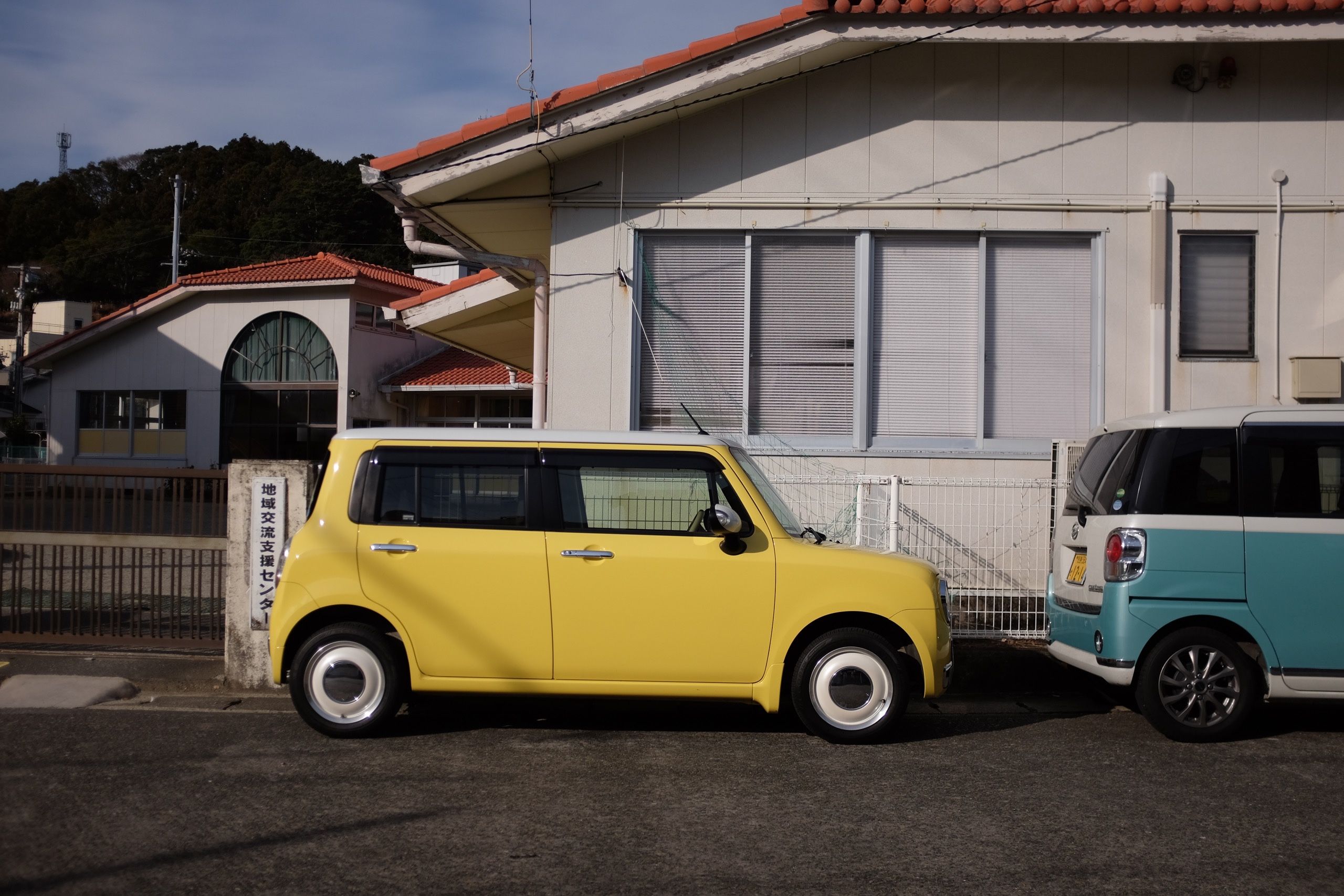 A small, yellow, boxy-looking car.