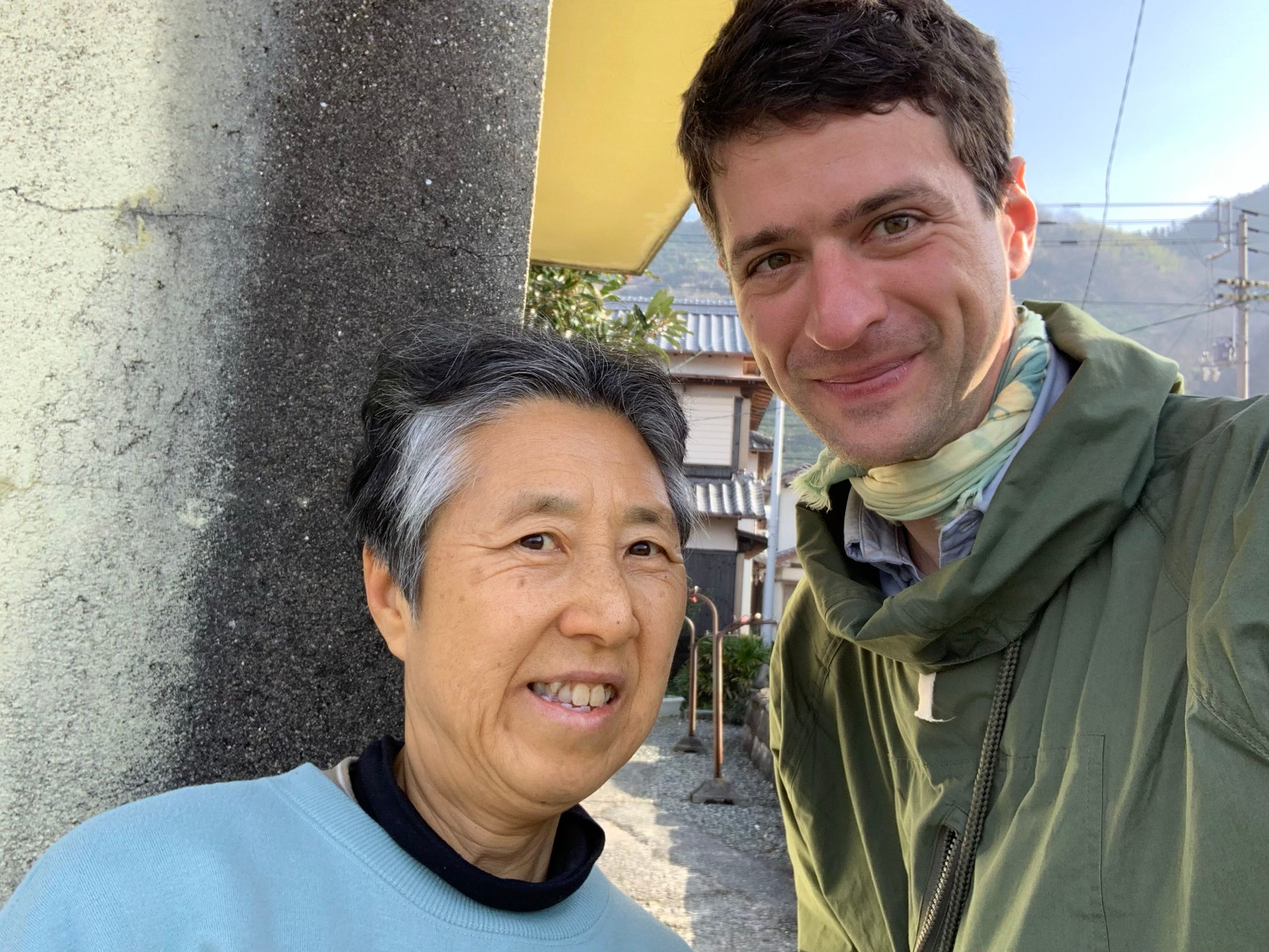 A Japanese woman and a much taller European man, the author, pose for the camera.