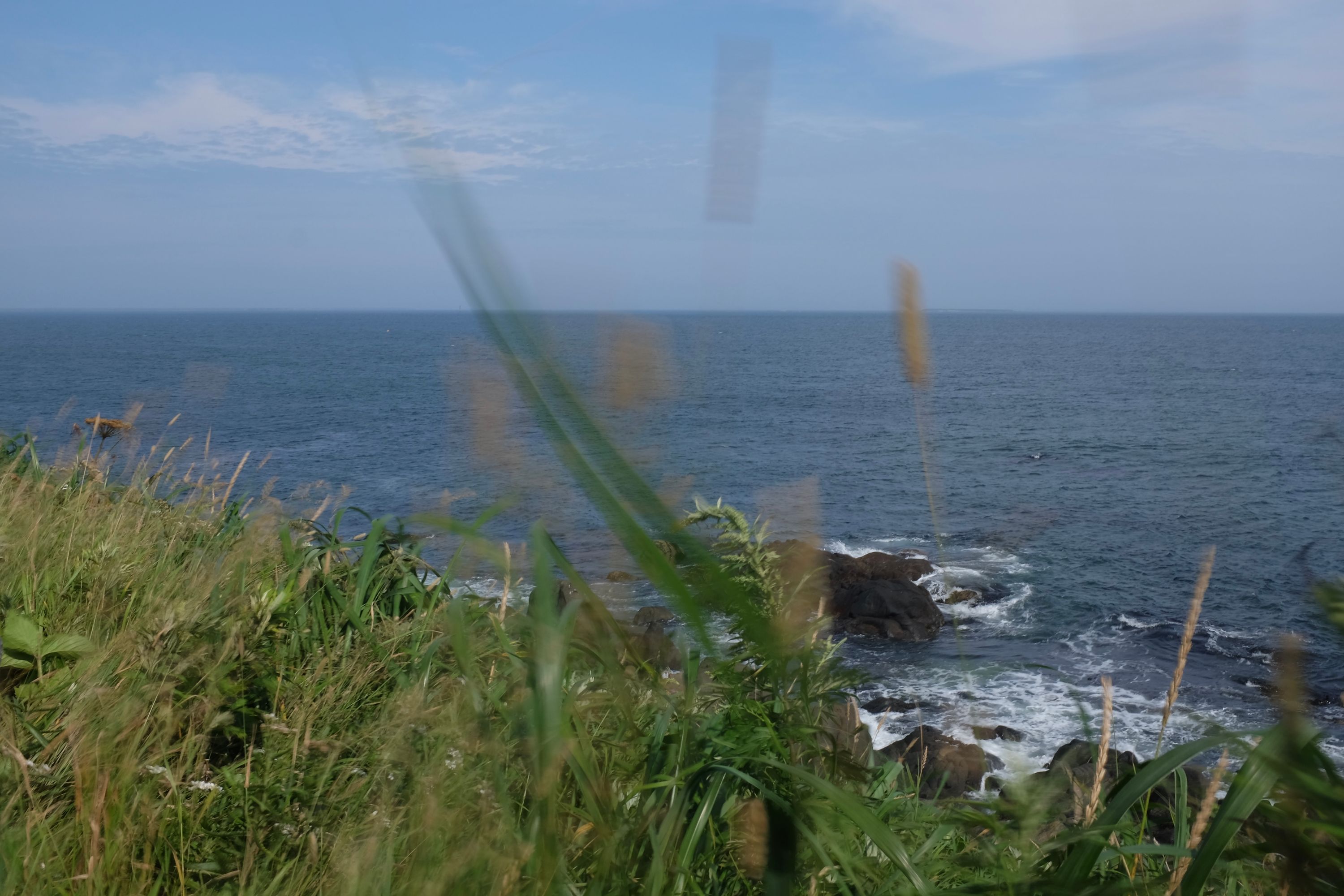 A black rock by the shore at the eastern end of the Japanese mainland.