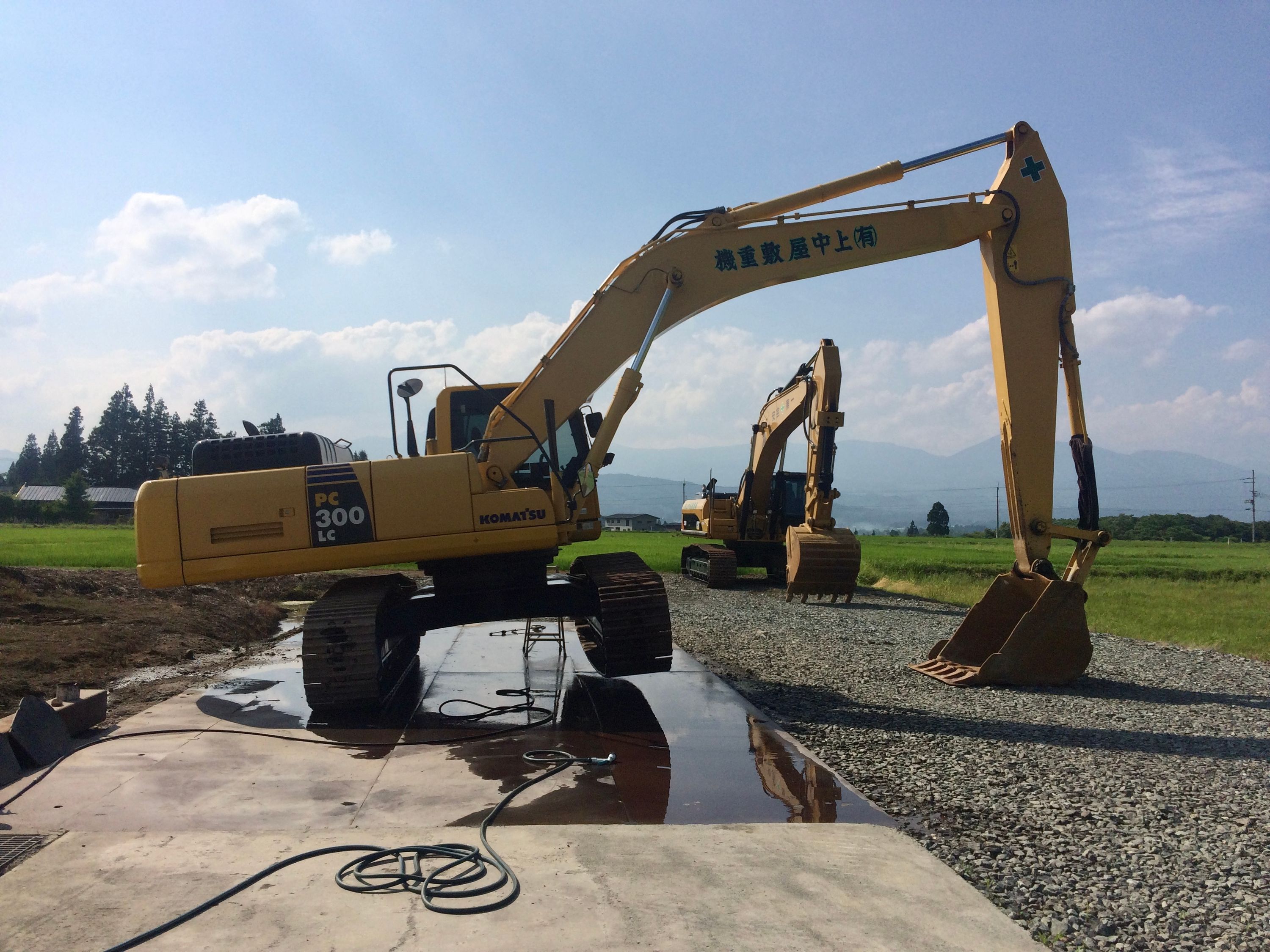 An excavator parked on only one of its tracks.