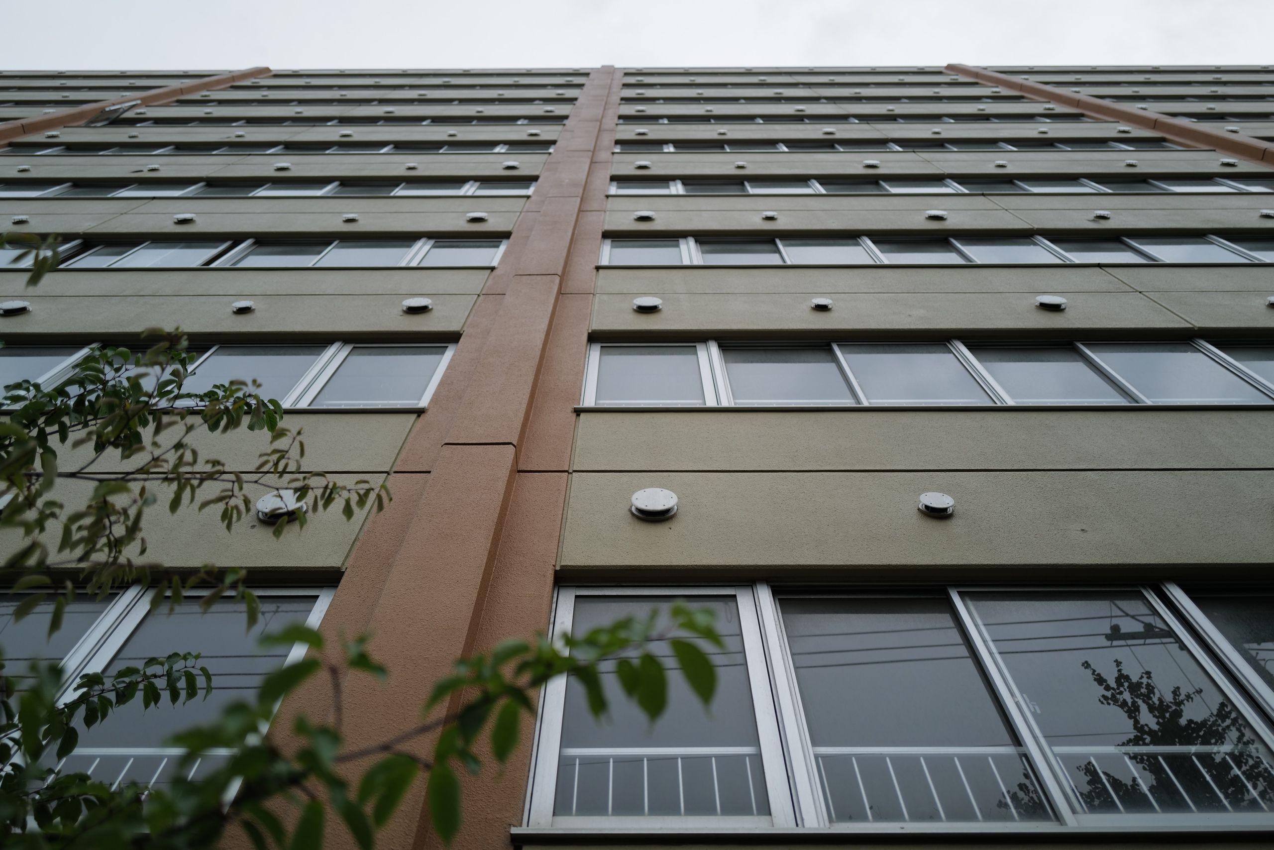 Looking up at a building that looks just like a Soviet housing estate block but is in fact Japanese