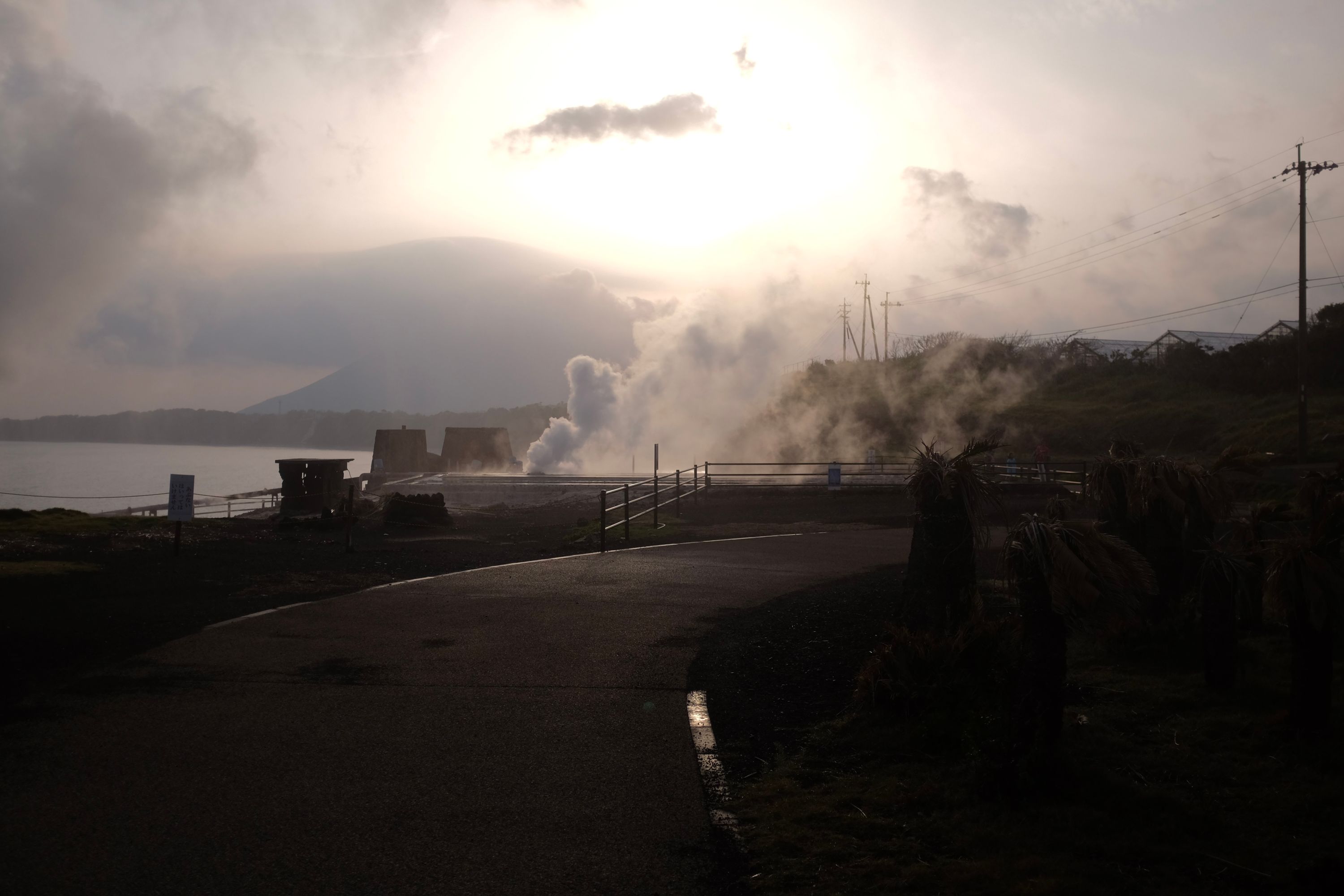 Mount Kaimon visible in the distance through clouds of hissing steam.