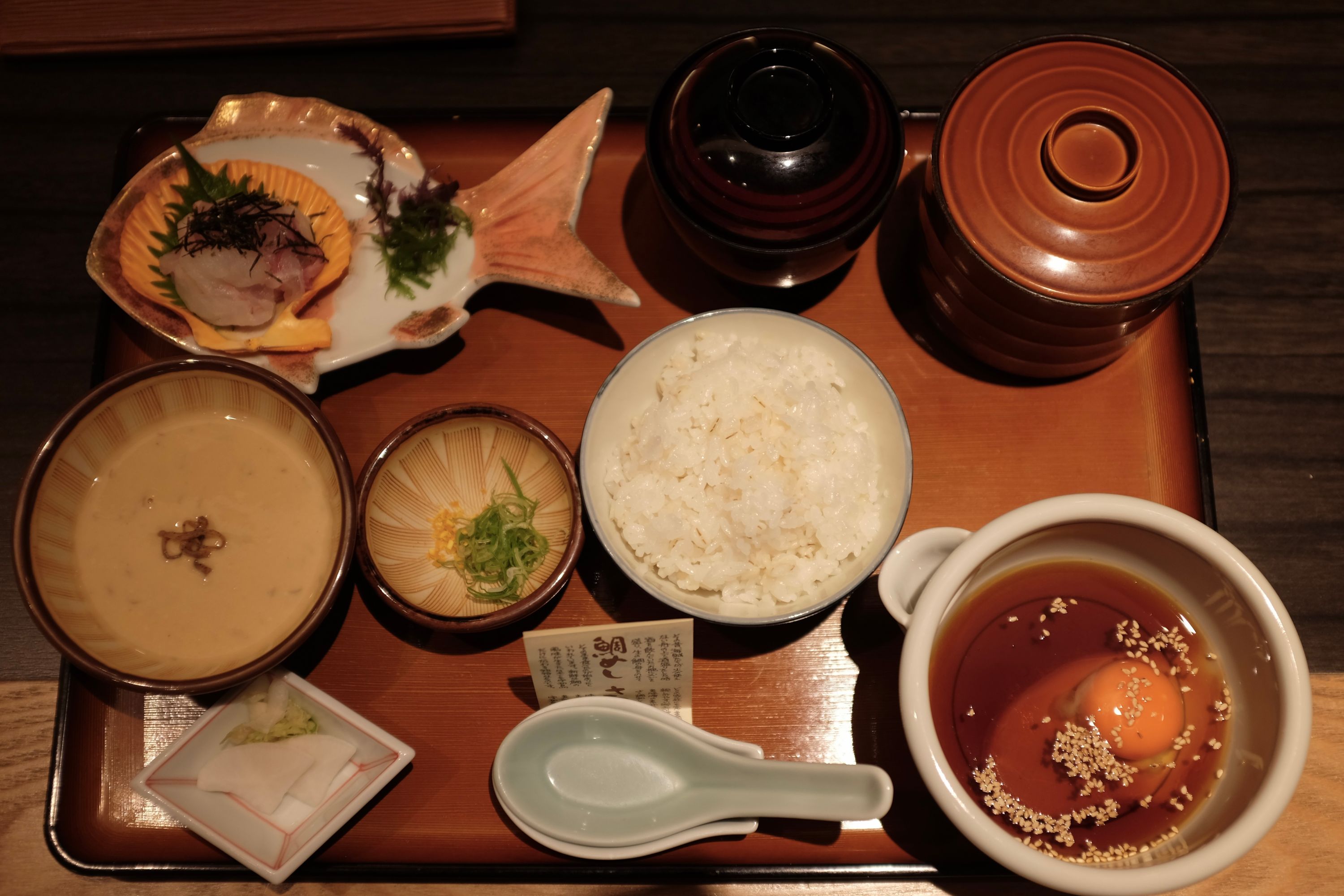 A beautifully presented set meal of sea bream, rice, miso soup, and various small plates.