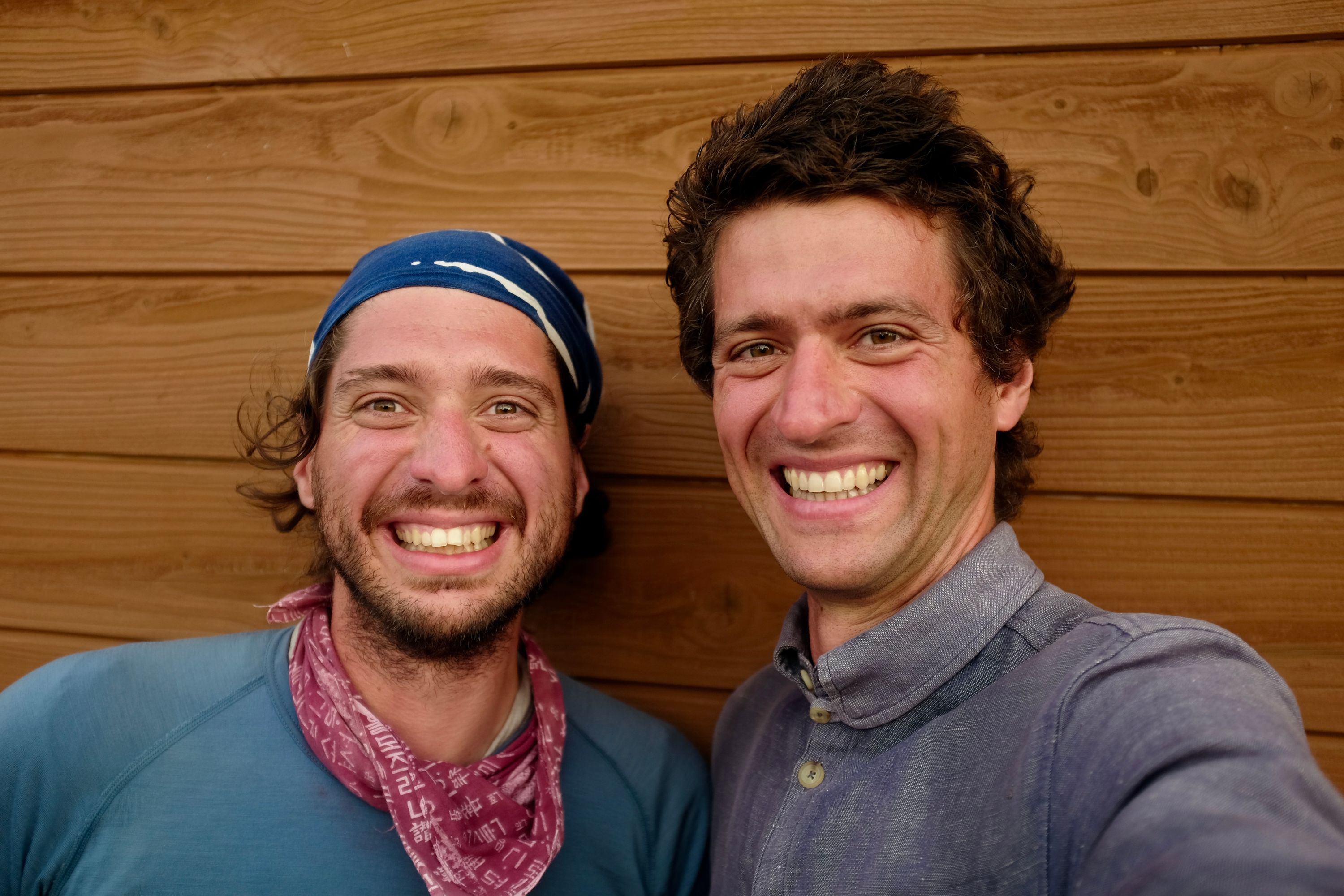 Gabor and Peter Orosz smile into the camera, looking happy and scruffy