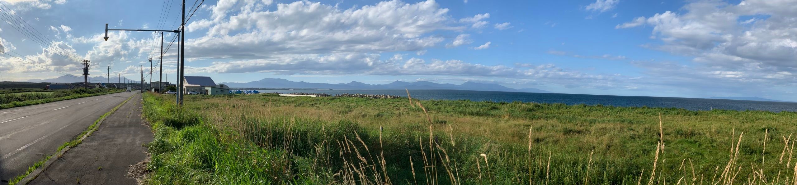 Panorama on a sunny day with a chain of volcanoes on the horizon.